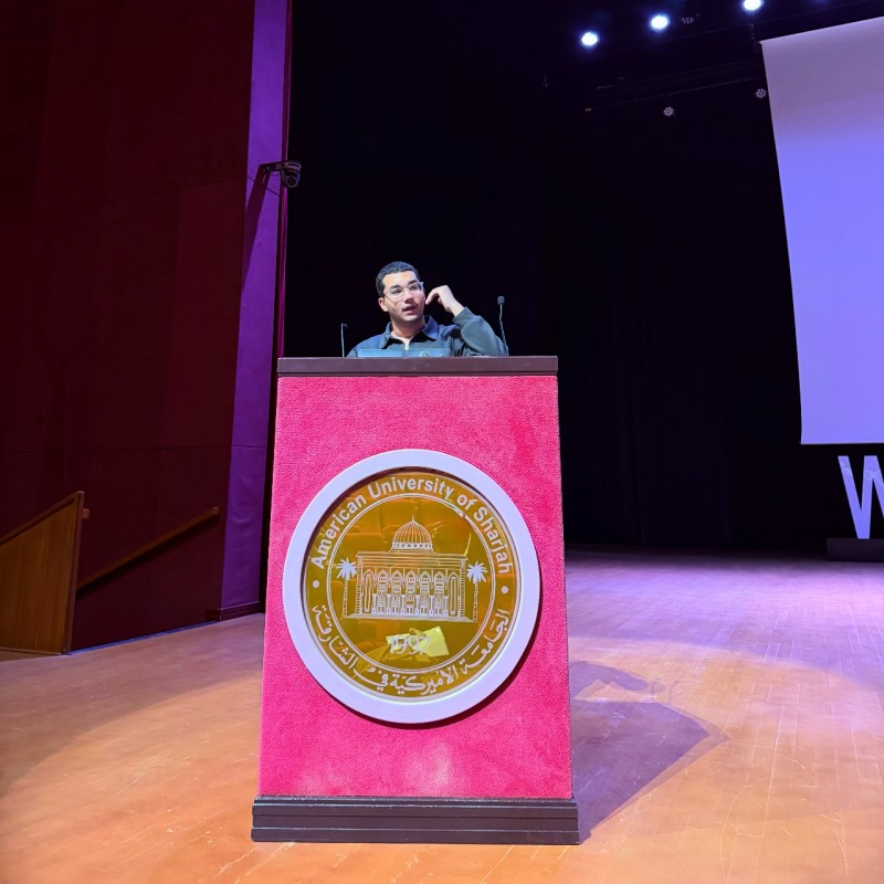 Ahmed AbdelMohsen speaking at an AUS podium